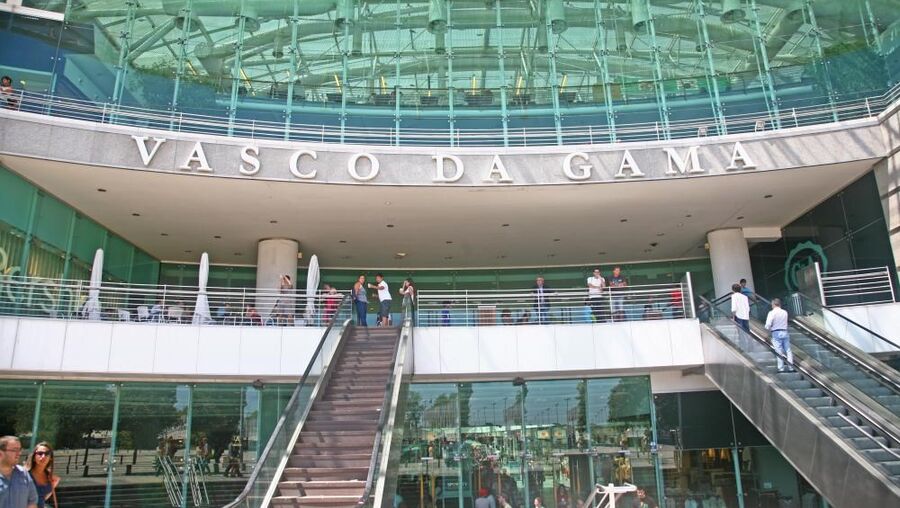 The glass ceiling of the shopping center brings natural light to the building